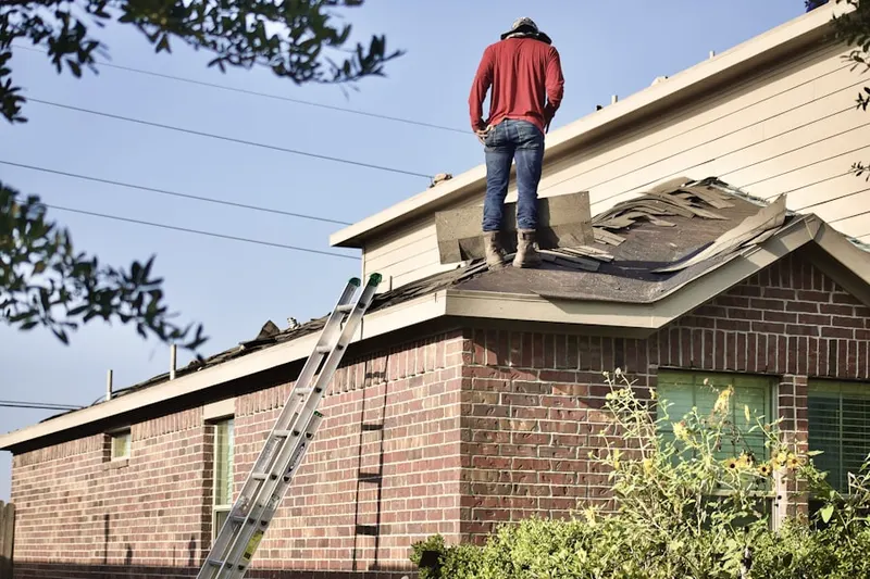 Professional roofer working on a residential roof in Hampton Hall